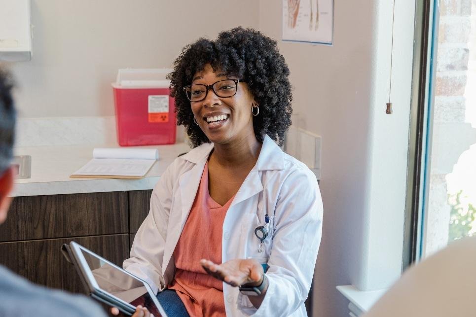 Healthcare professional discussing medical history and wellness concerns with a patient during a consultation.
